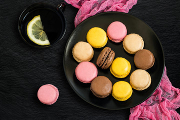 Different macaroon on black plate