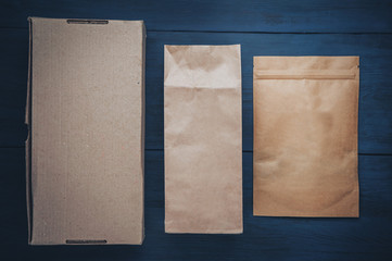 Kraft packaging of different sizes on a wooden background.