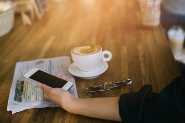 woman using on mobile phone during rest in coffee shop