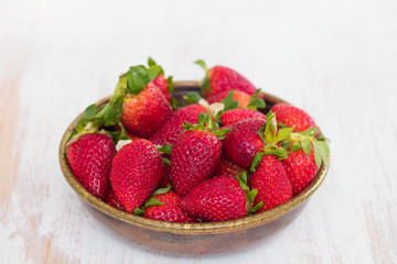 strawberries in dish on ceramic background