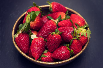 strawberries in dish on ceramic background