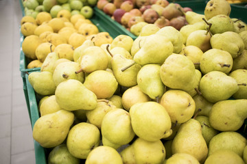 fresh yellow pears in boxes in the store