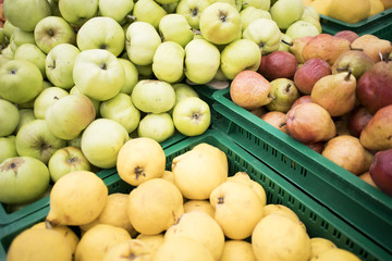 fresh pears and apples in boxes in the store