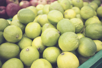 craft box with fresh limes. Lime harvest. many limes. lime close up.