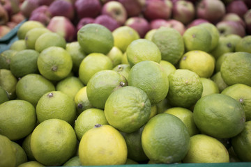 craft box with fresh limes. Lime harvest. many limes. lime close up.