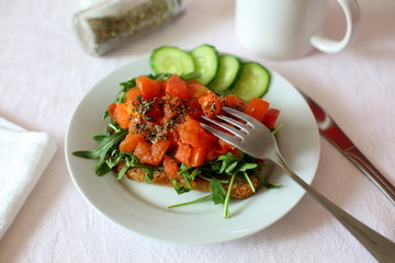 toast with stewed tomatoes and cucumber on white background