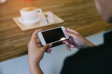 woman using on mobile phone during rest in coffee shop