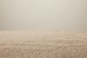 close up view of sand texture on grey backdrop