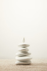 close up view of arranged white sea stones on sand on grey background