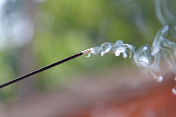 Incense stick and smoke from incense burning. Beautiful smoke. Blurred background and design with...
