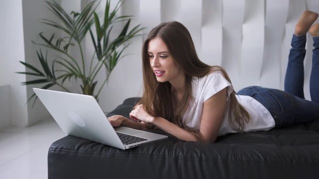 Attracitve young woman using her laptop at home
