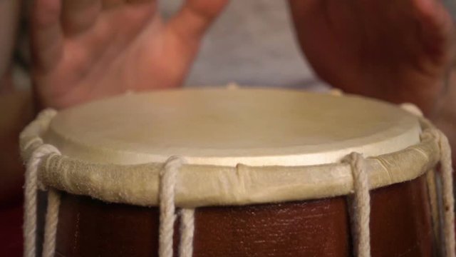 Close up of hands of a man playing a drum. Slow Motion.