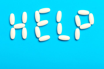Pills are scattered over a blue background