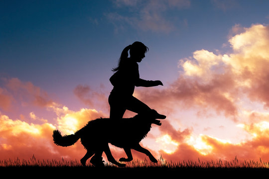 girl runs with dog at sunset