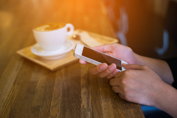 woman using on mobile phone during rest in coffee shop