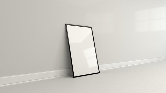 Blank White Poster In Black Frame Standing On The Floor