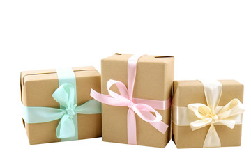 Rustic composition w/ bunch of beautiful presents in craft paper wrapping. Close up of many gifts in brown wrap with ribbon and bow.