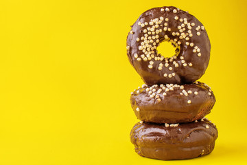 pyramid of chocolate donuts, on a yellow background