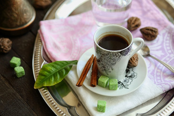 espresso Cup, Turk, glass of water on a tray on a dark wooden table.
