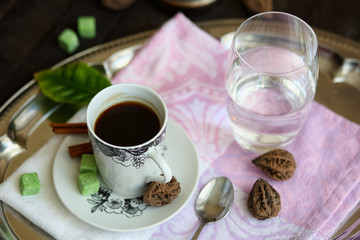 espresso Cup, Turk, glass of water on a tray on a dark wooden table.