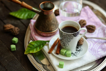 espresso Cup, Turk, glass of water on a tray on a dark wooden table.