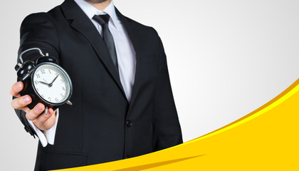 Unrecognizable businessman showing you black alarm clock. Business concept