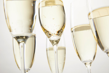 cropped image of champagne glasses with bubbles isolated on white backgronud