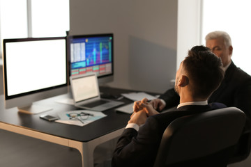 Fototapeta na wymiar Male brokers working in office. Finance trading concept
