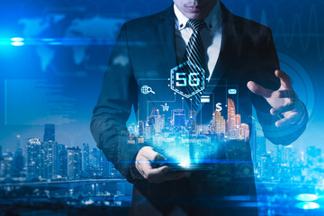 The abstract image of businessman using a smartphone overlay with 5g and cityscape hologram. the concept of 5G, communication, network, connection, internet of things.