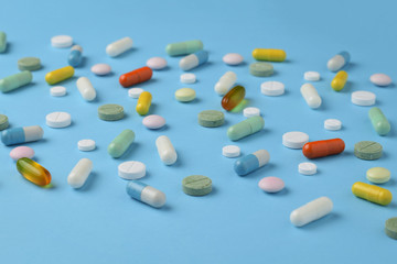 Unsorted pharmaceutical preparations on a blue background