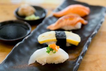 Assorted varieties of sushi platter. Raw fish sushi. Japanese food. Salmon burn, salmon, ika and tamago sushi in Japanese food restaurant..