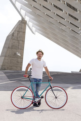 young man using a fixed gear bicycle in the street.