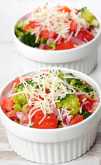 small white bowl with tomatoes and broccoli
