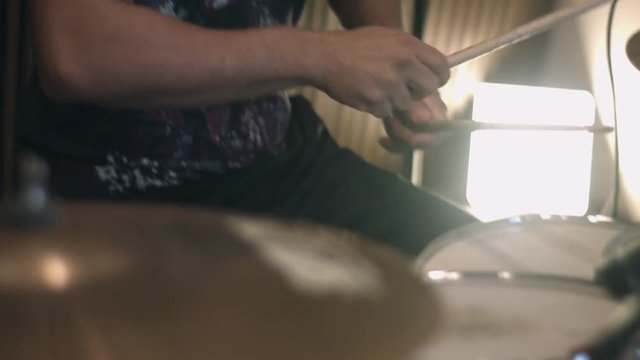 The drummer in action. Man playing drums in studio, drummer rock concept.