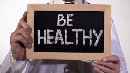 Be healthy text on blackboard in doctor hands, immune system, active lifestyle