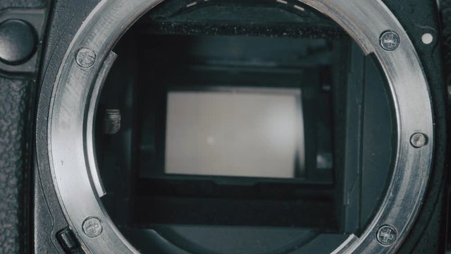 close up of The matrix of the mirror photo camera. The shutter of the camera is working, the resource of the camera shutter, the concept of repair and maintenance of photo equipment