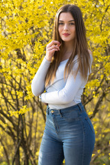 Young girl portrait with yellow bush