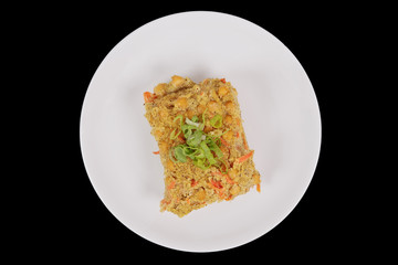 Polenta with poppy and vegetables on a black