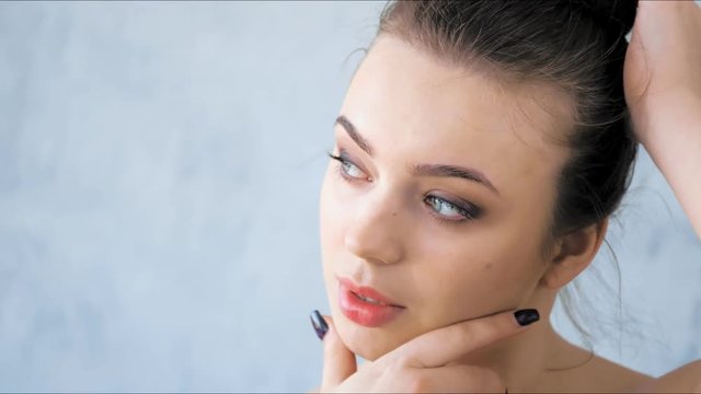 Close-up of fashion young woman with clean and healthy skin in studio