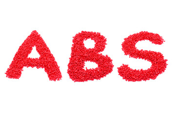 The words ABS of red plastic polymer isolated on a white background.