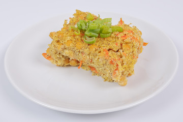 Polenta with poppy and vegetables on a white