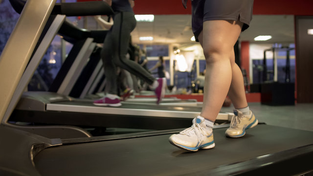 Feet Of Fat Woman Walking Slowly On Treadmill, Healthy Life, Exercising In Gym