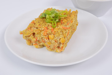 Polenta with poppy and vegetables on a white