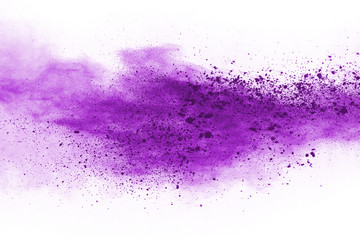 Powder explosion. Closeup of a purple dust particle explosion isolated on white. Abstract...