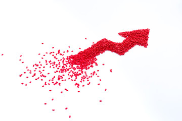 Red arrow design of plastic polymer granules isolated on white background