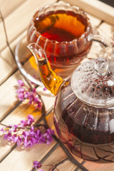 cup and kettle of  black tea 