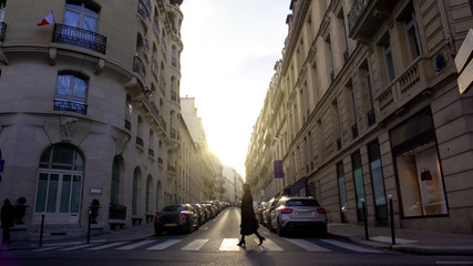 Fototapeta na wymiar Pedestrian crossing street in European city, woman walking home from work