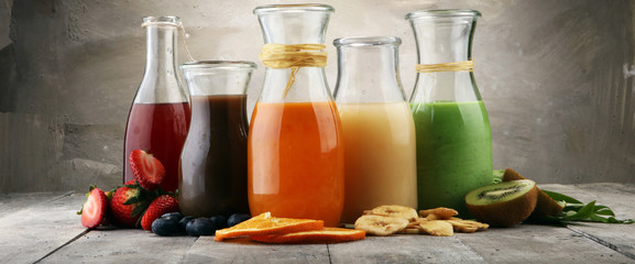 Selection of colorful smoothies on rustic background