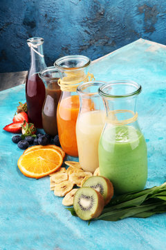 Selection of colorful smoothies on rustic background