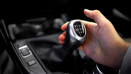 Male hand holding manual gearbox in car, test drive of new automobile, closeup - 201370249